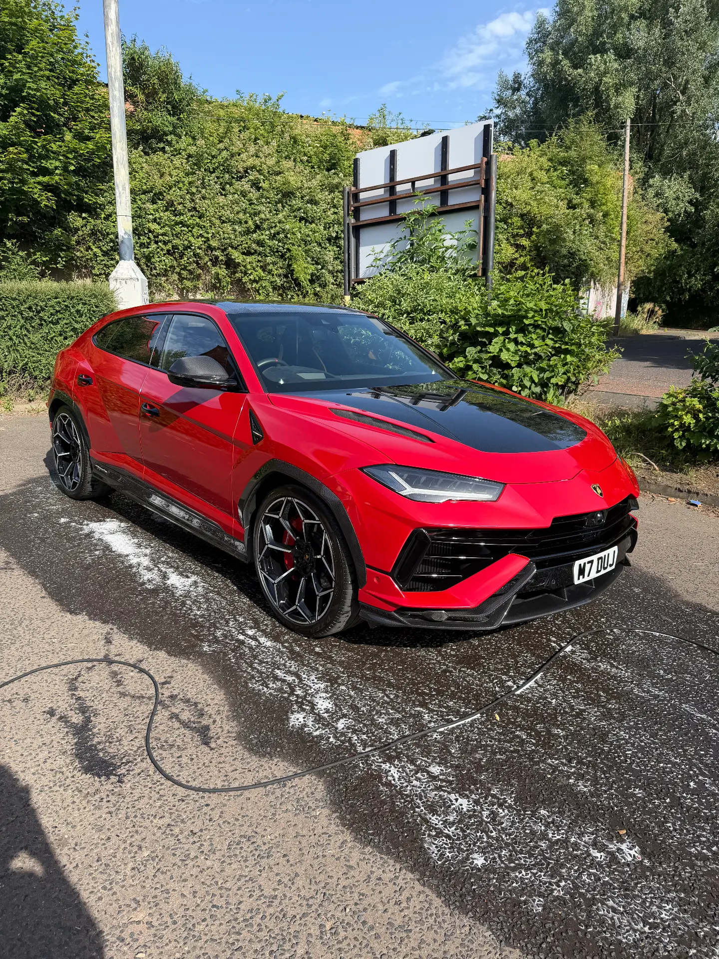 Red Lamborghini Urus mid-wash foam